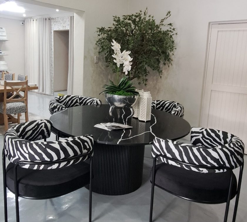 Styled dining table with zebra-print accent chairs